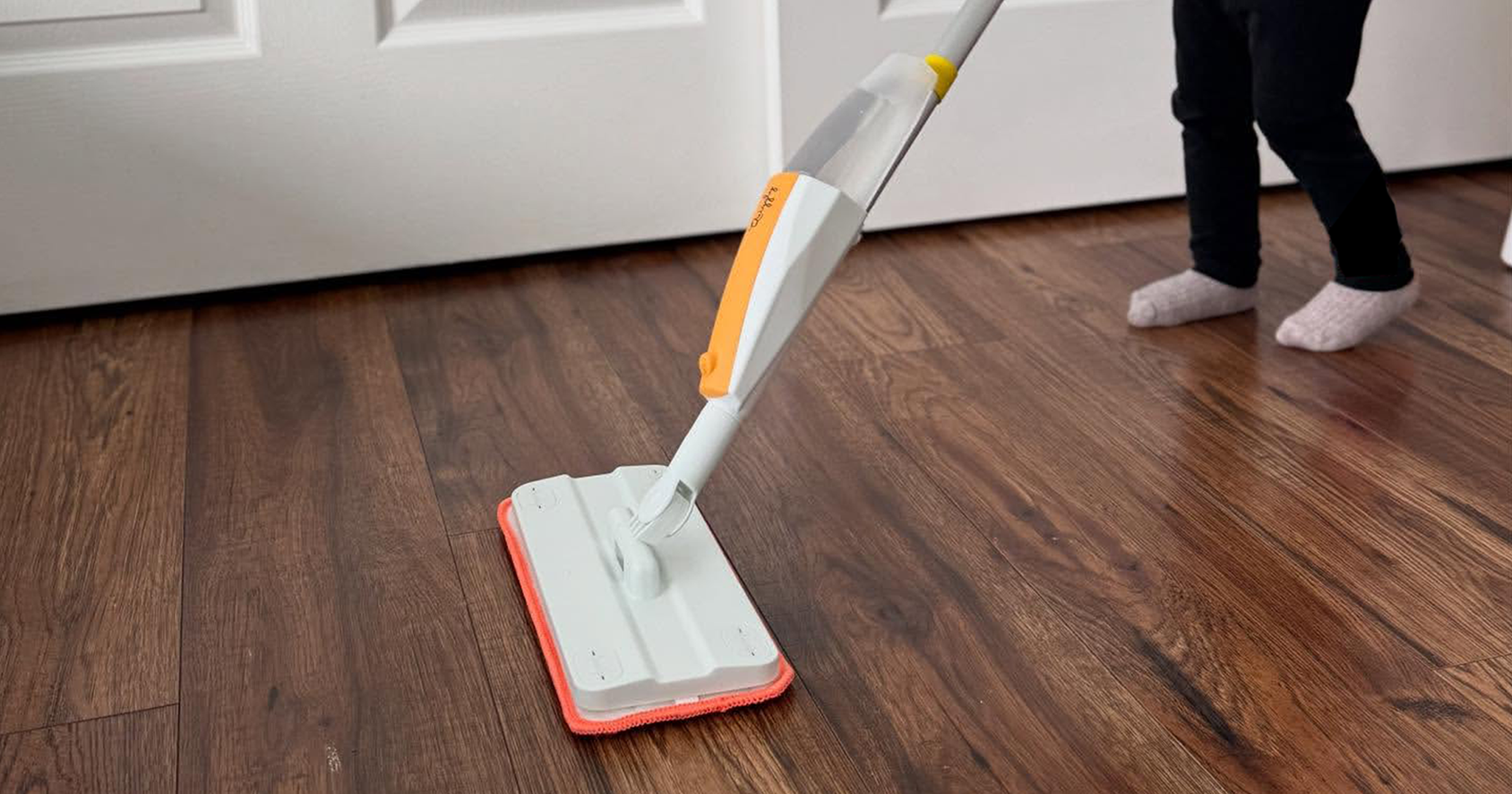 Montessori toddler doing real cleaning with toy mop