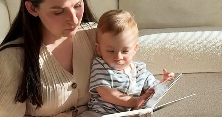 Mom and toddler reading a high-contrast board book together at home