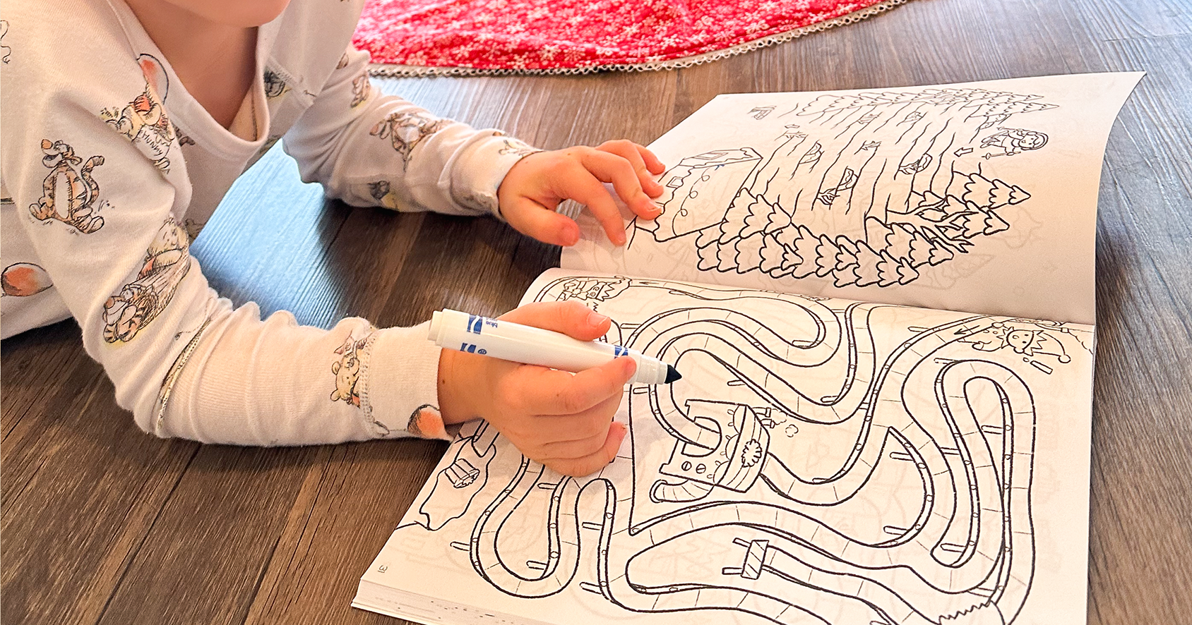 A child completes a maze from Quiggly's Merry Mazes - holiday maze book for kids 4-8