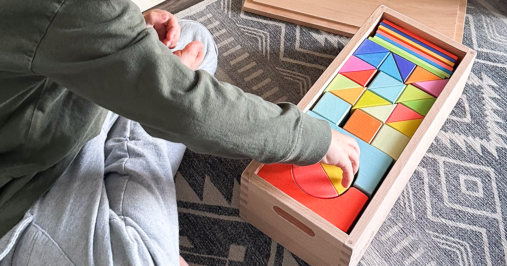 Open-ended wooden rainbow blocks set out for imaginative play