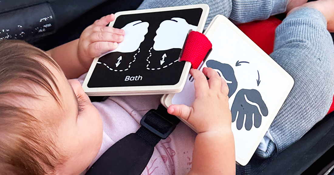 Toddler exploring a simple, realistic board book