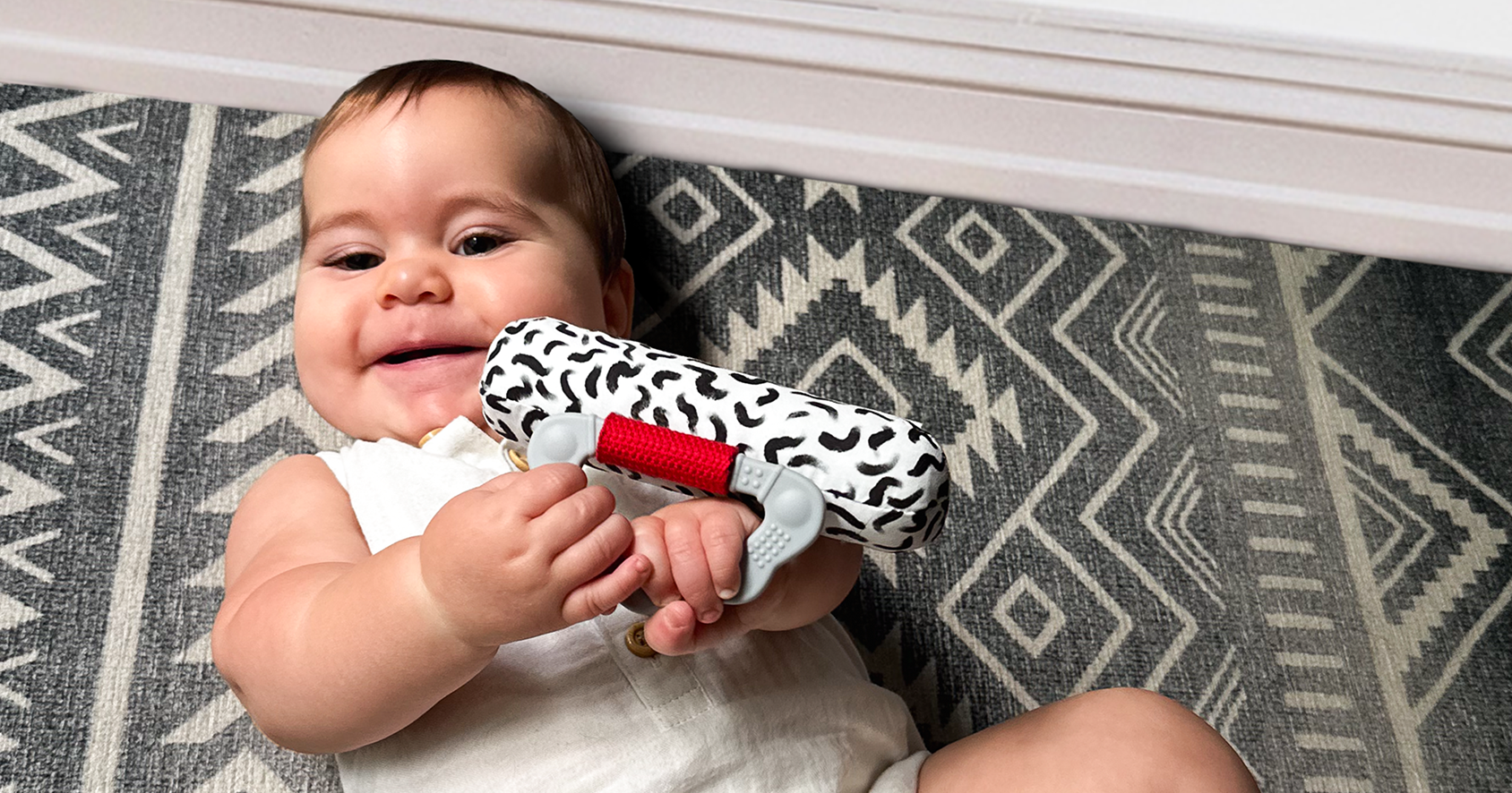 baby playing with high contrast soft cotton fabric rattle for early sensory development