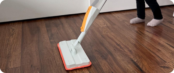 A kid mopping the floor with the Kid Toy Real Spray Mop