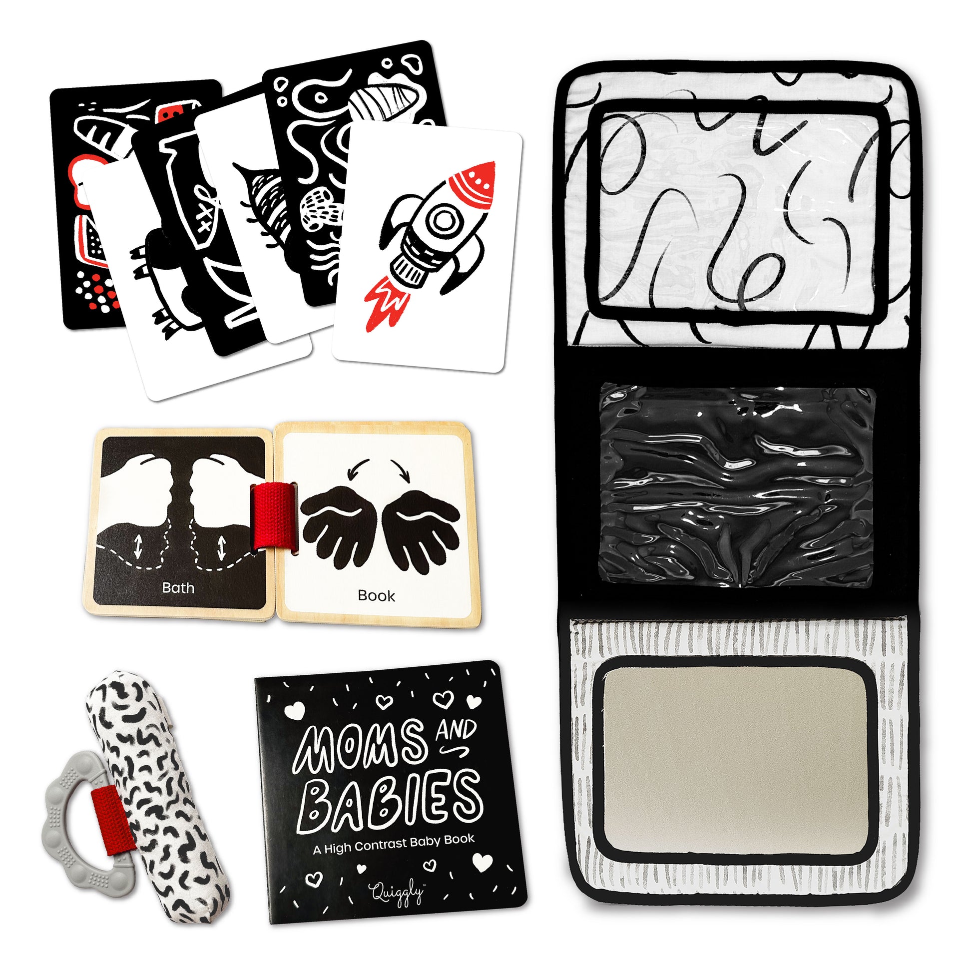 Flatlay of 5-in-1 black, white & red newborn toy set with board books, flashcards, rattle, and stand
