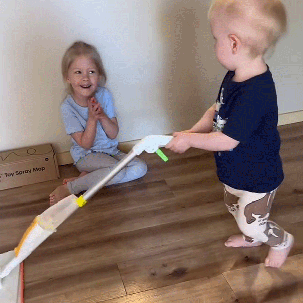Older sister cheering on her toddler sibling actually mopping the floor with Quiggly real spray mop
