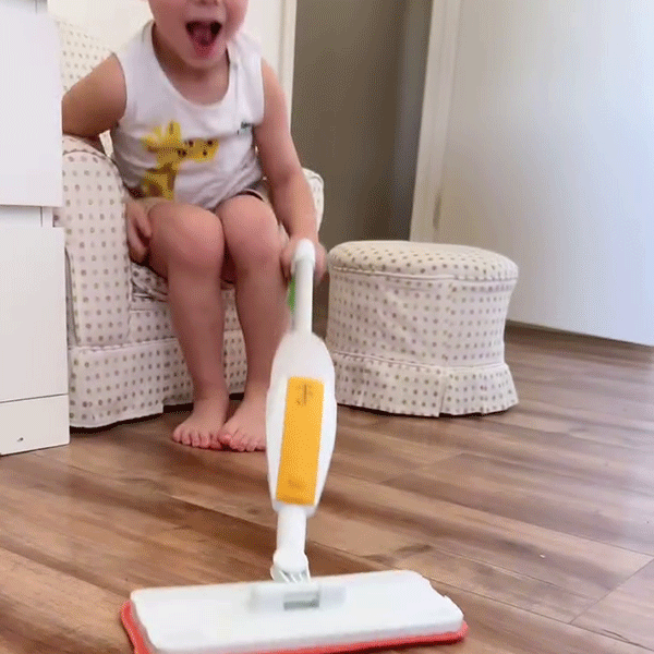 Child building real life cleaning habits with Quiggly kids spray mop