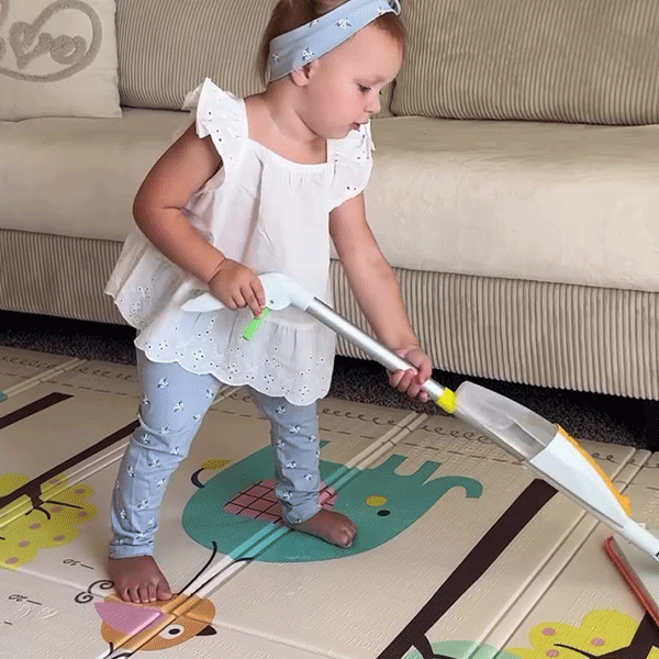 Young child practicing mopping with Quiggly kids spray mop