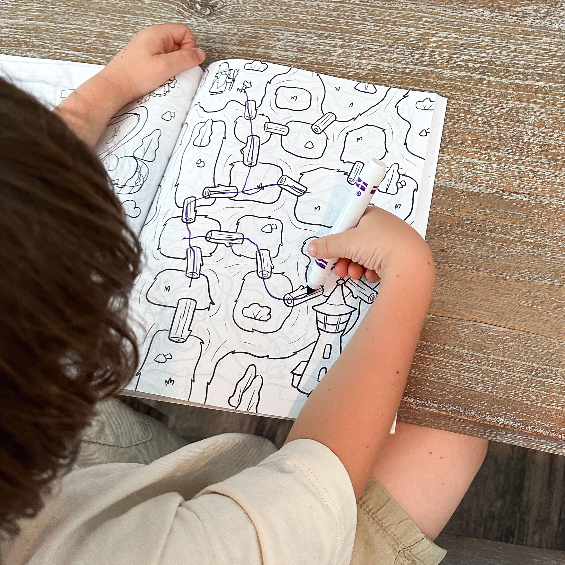 Over-the-shoulder view of child engaged in maze-solving fun with Quiggly Maze Craze book