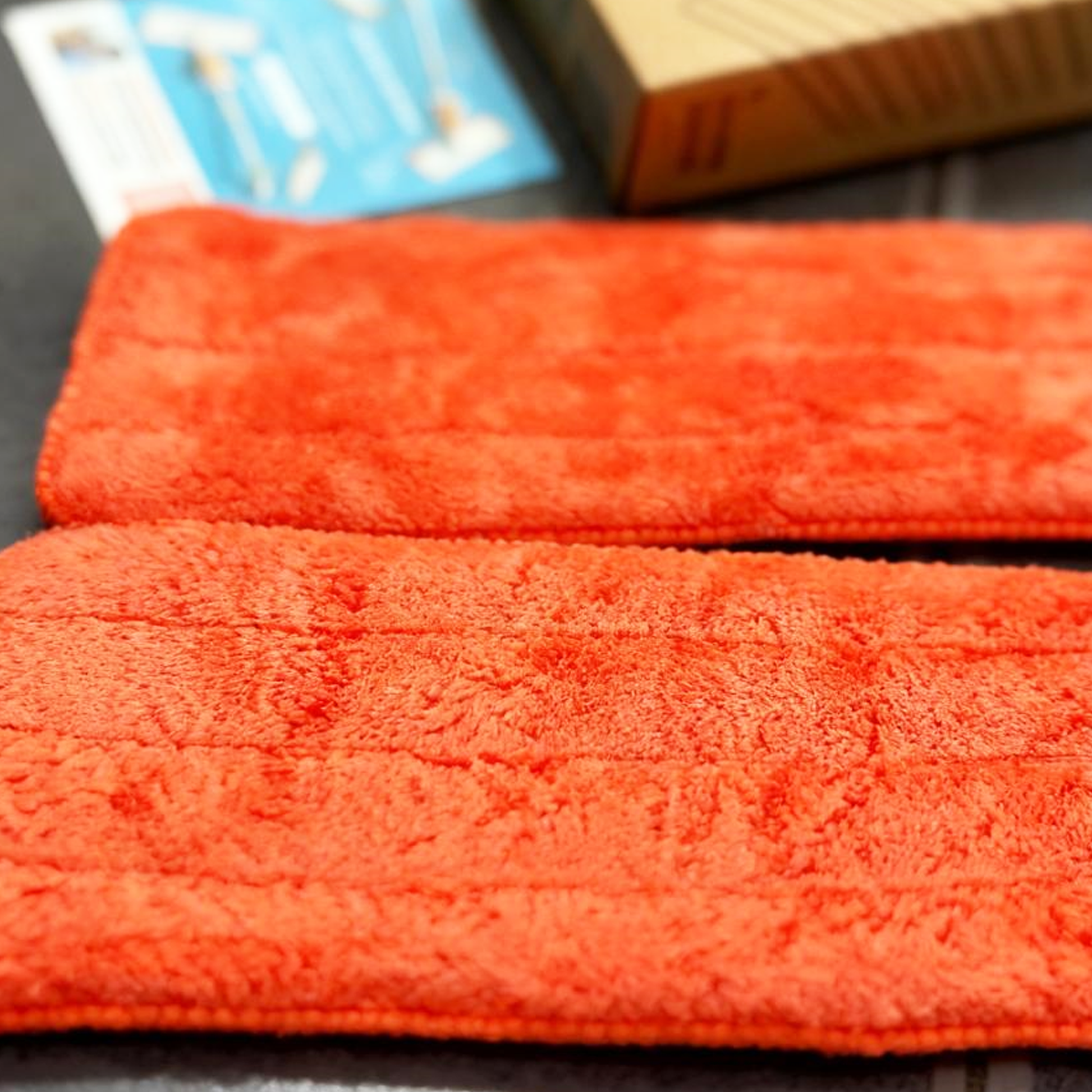 Close-up of two red textured microfiber mop pads for Quiggly Toddler Spray Mop